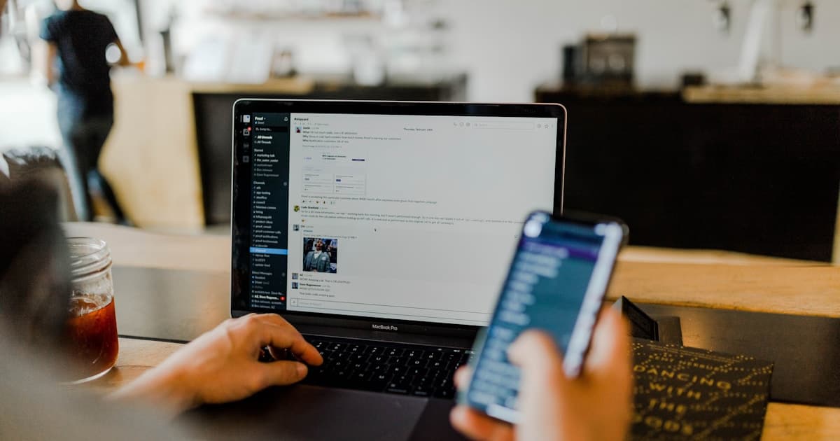 Person overwhelmed by multiple screens and notifications, representing AI-generated noise